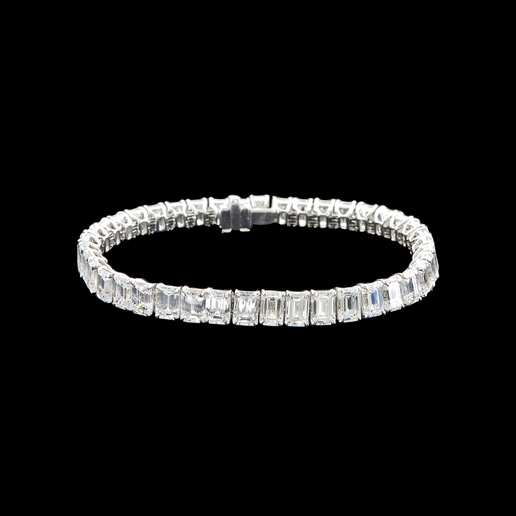 - A 20.00 tcw emerald cut diamond tennis bracelet set in 18k white gold